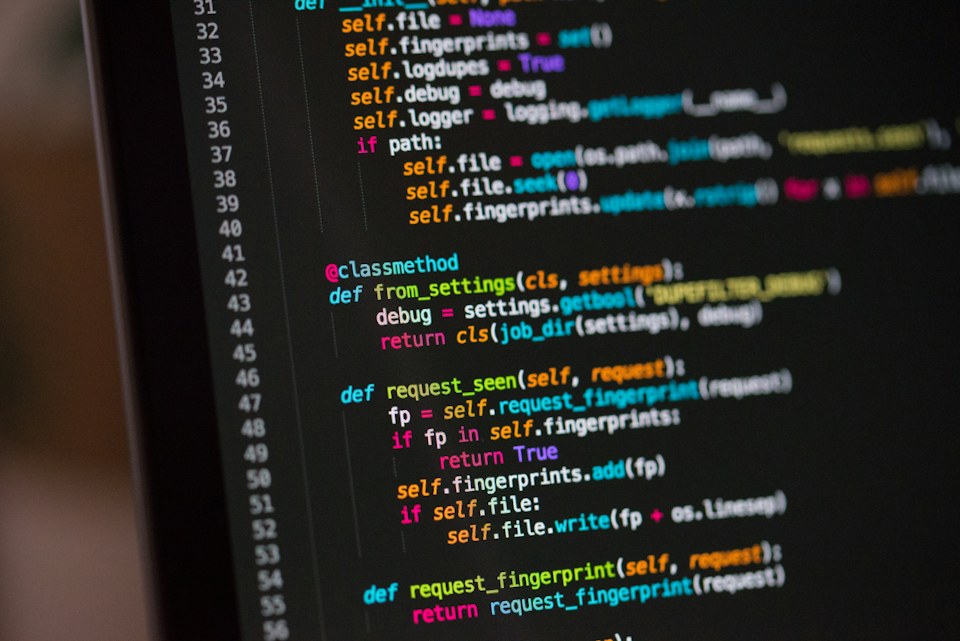 Software developer writing code on a computer